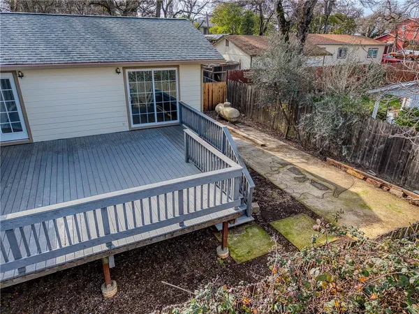a backyard of a house with table and chairs