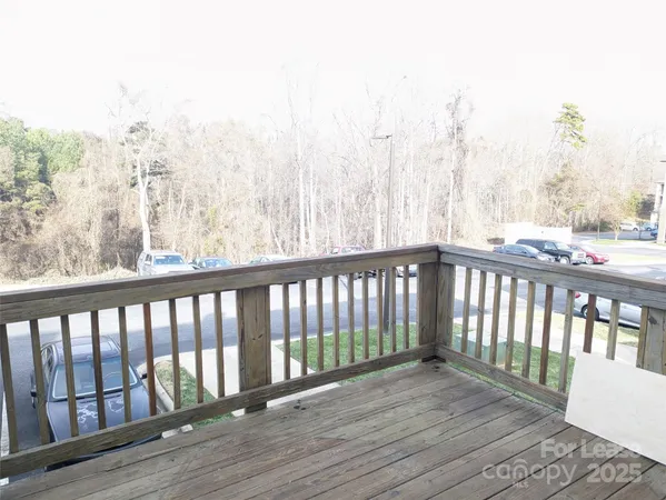 a balcony with wooden floor and fence