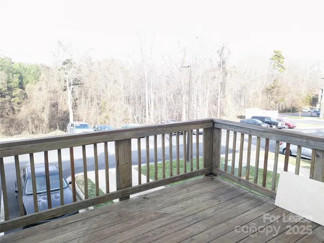 a balcony with wooden floor and fence