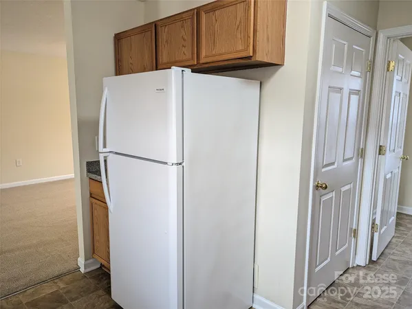 a white refrigerator freezer and a microwave in a kitchen