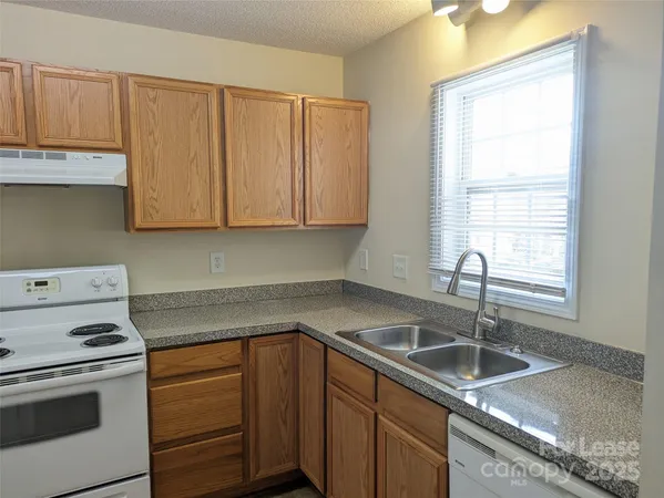 a kitchen with a sink cabinets and window