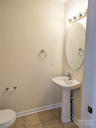 a bathroom with a sink toilet and a mirror