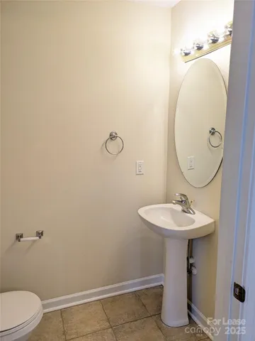a bathroom with a sink toilet and a mirror