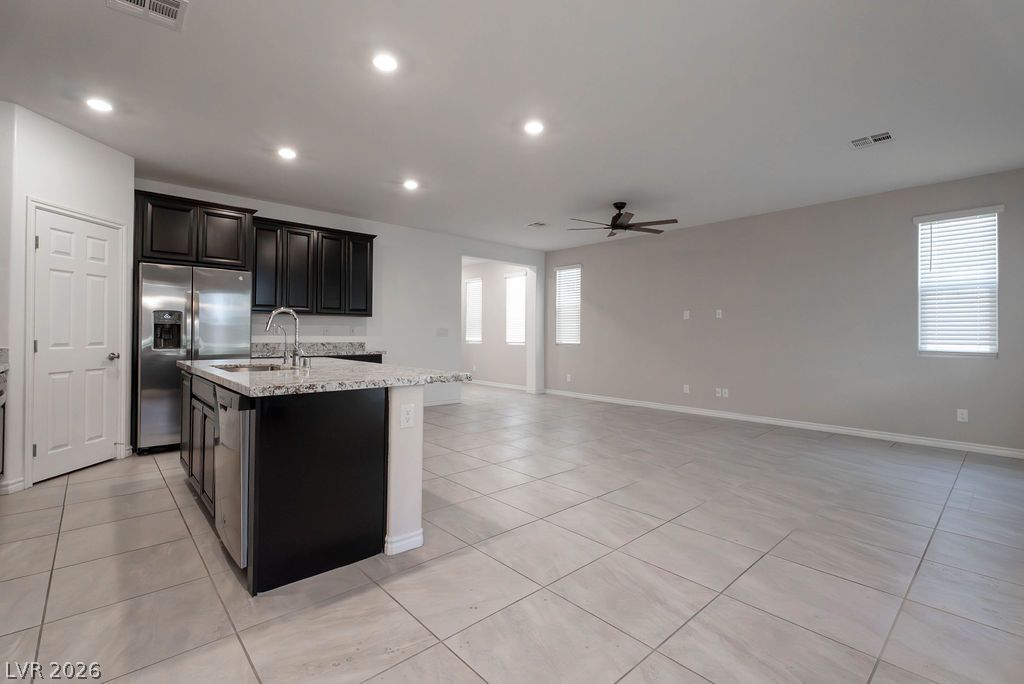 7126 Calvert Cliffs Street North Las Vegas, NV 89084 - Photo 44 of 44 An open concept floorplan features a well-appointed kitchen flowing into a spacious living area with bright windows.