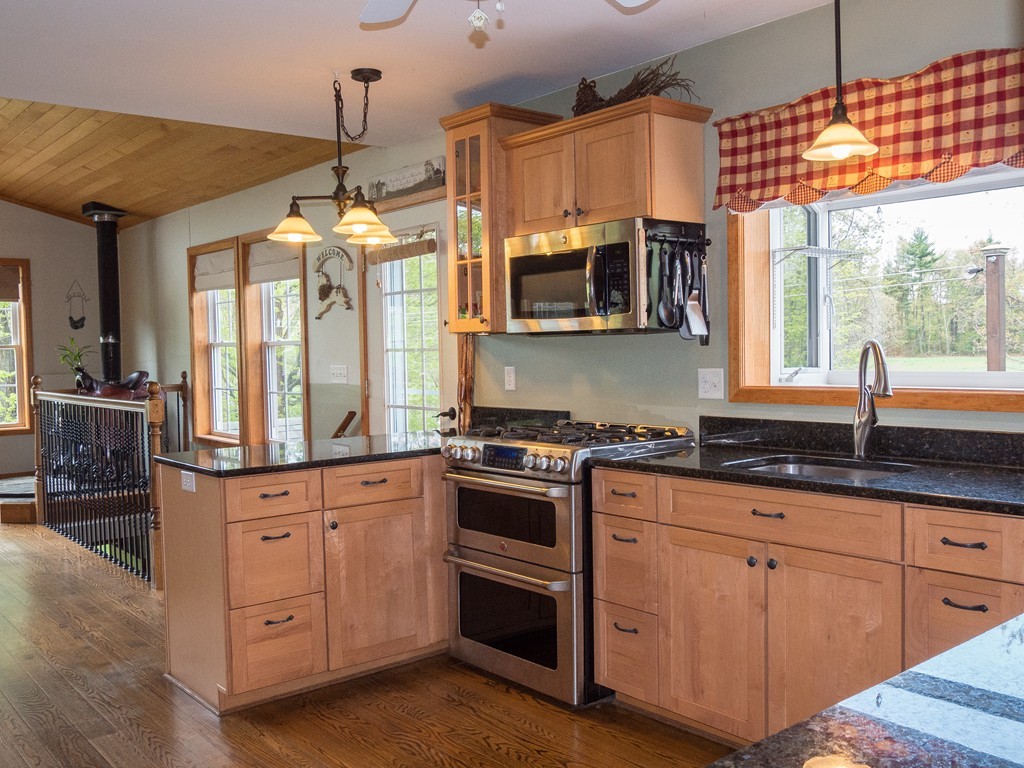 32 Old County Road Southampton, MA 01073 - Photo 3 of 23 a kitchen with granite countertop white cabinets and window