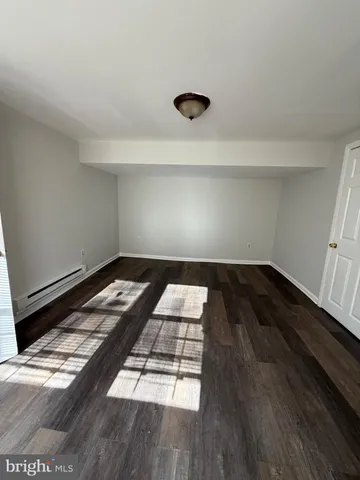 a bedroom with bed and wooden floor