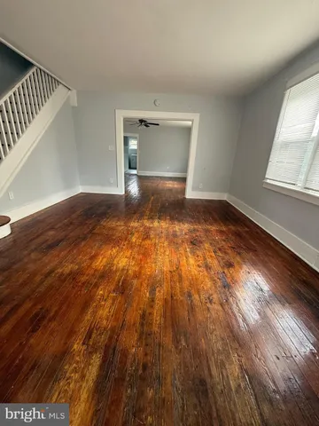 a view of an empty room and wooden floor