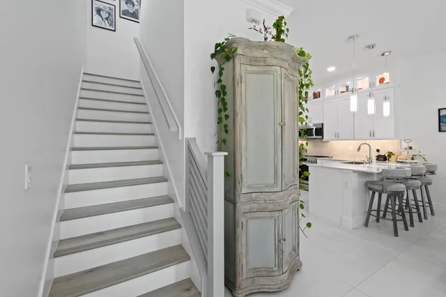 a bathroom with a double vanity sink toilet and shower