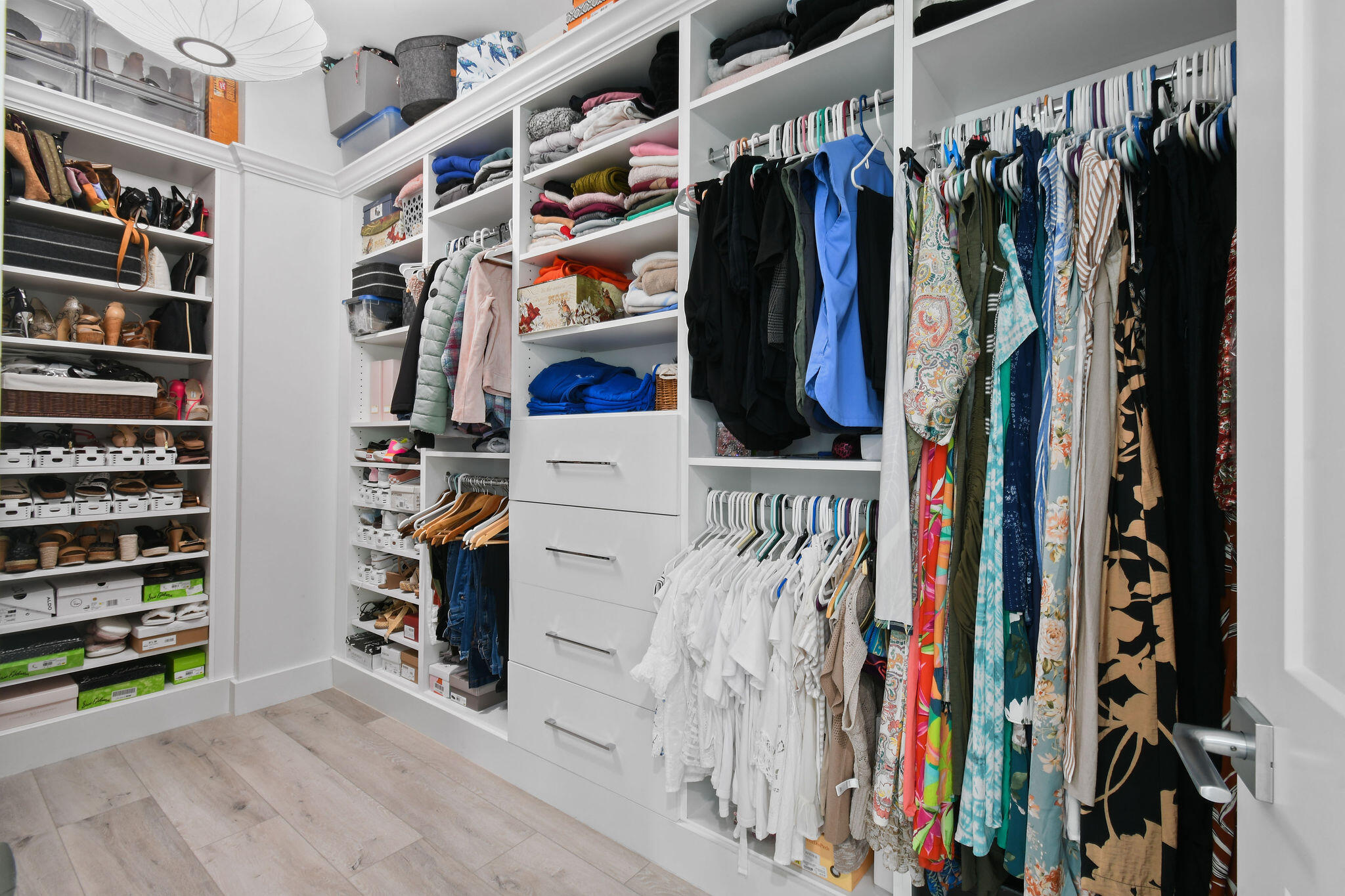 4707 Southeast Manatee Terrace Stuart, FL 34997 - Photo 25 of 68 a view of walk in closet with clothes and shoes