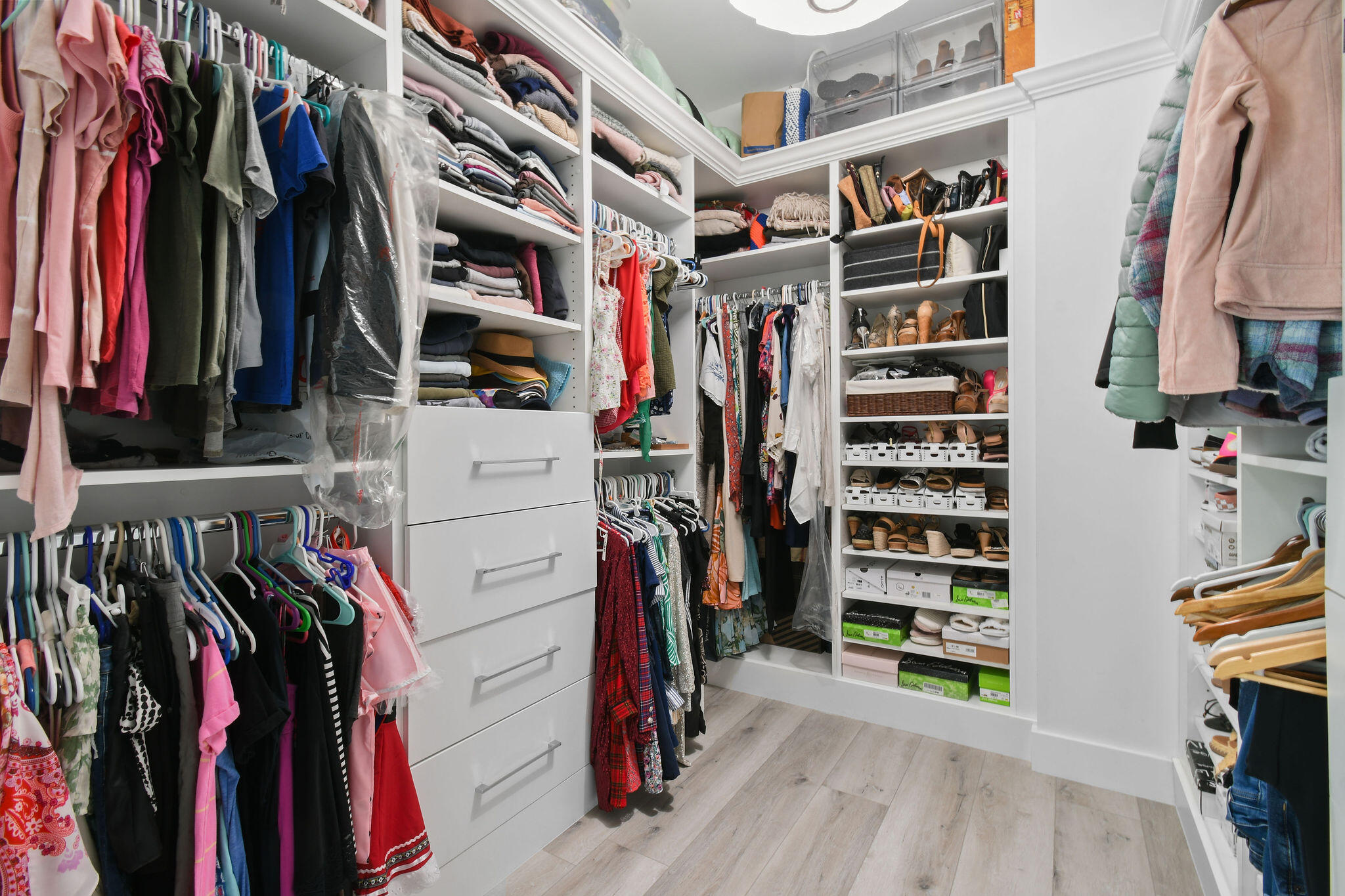 4707 Southeast Manatee Terrace Stuart, FL 34997 - Photo 26 of 68 a view of walk in closet with clothes and shoes