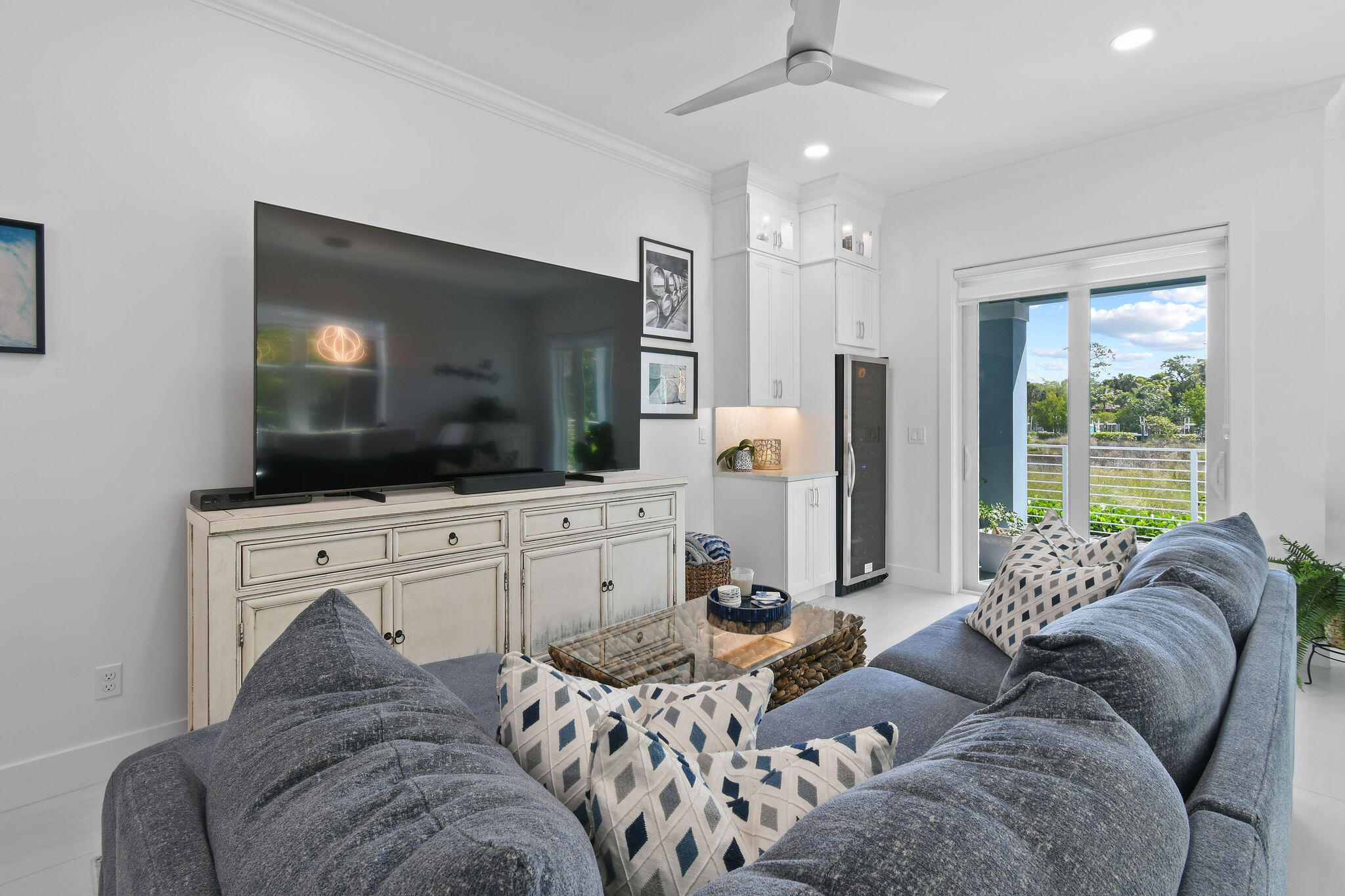 4707 Southeast Manatee Terrace Stuart, FL 34997 - Photo 3 of 68 a living room with furniture and a flat screen tv
