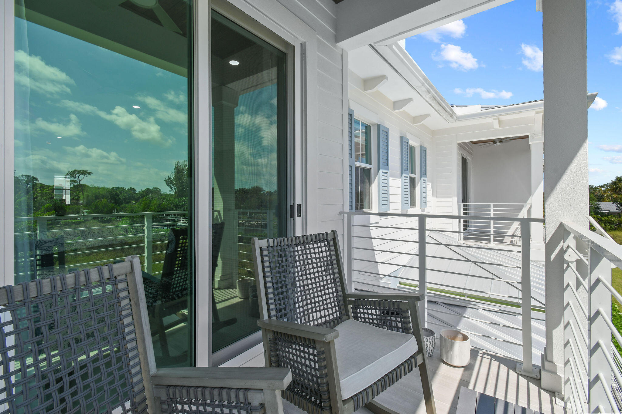 4707 Southeast Manatee Terrace Stuart, FL 34997 - Photo 33 of 68 a view of a balcony with chair and floor to ceiling window yard