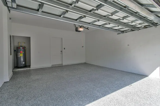 an aerial view of a house with garden space and lake view