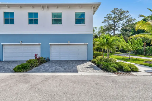 a view of a backyard with plants and patio