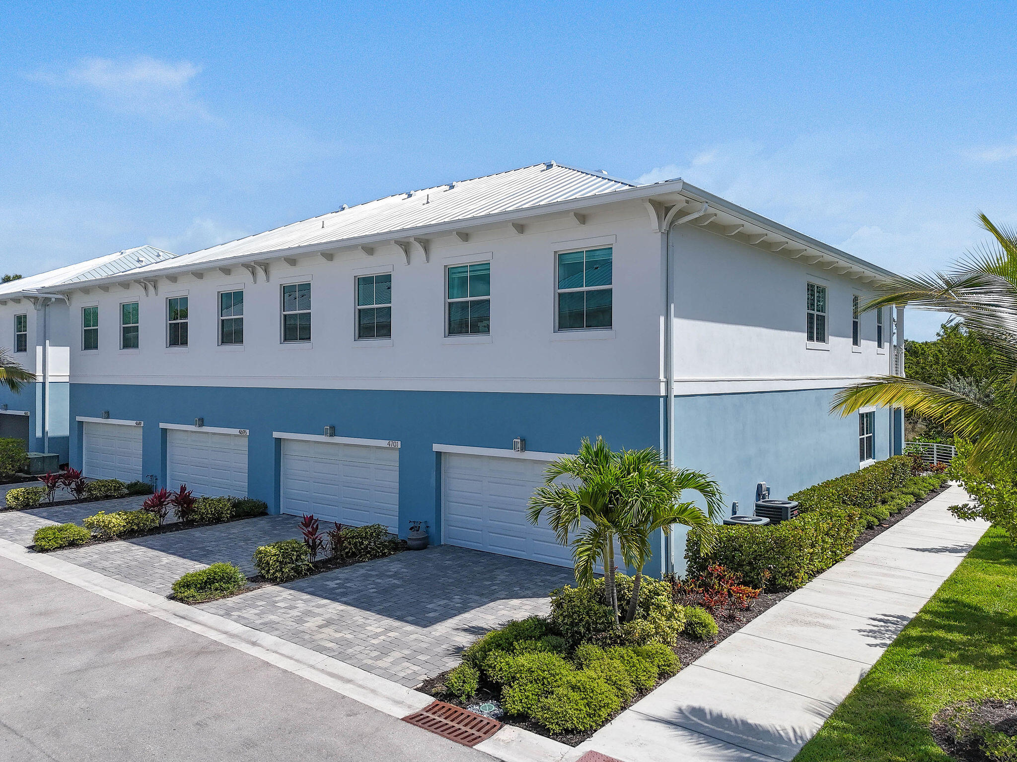 4707 Southeast Manatee Terrace Stuart, FL 34997 - Photo 52 of 68 a front view of a house with a yard and a garage
