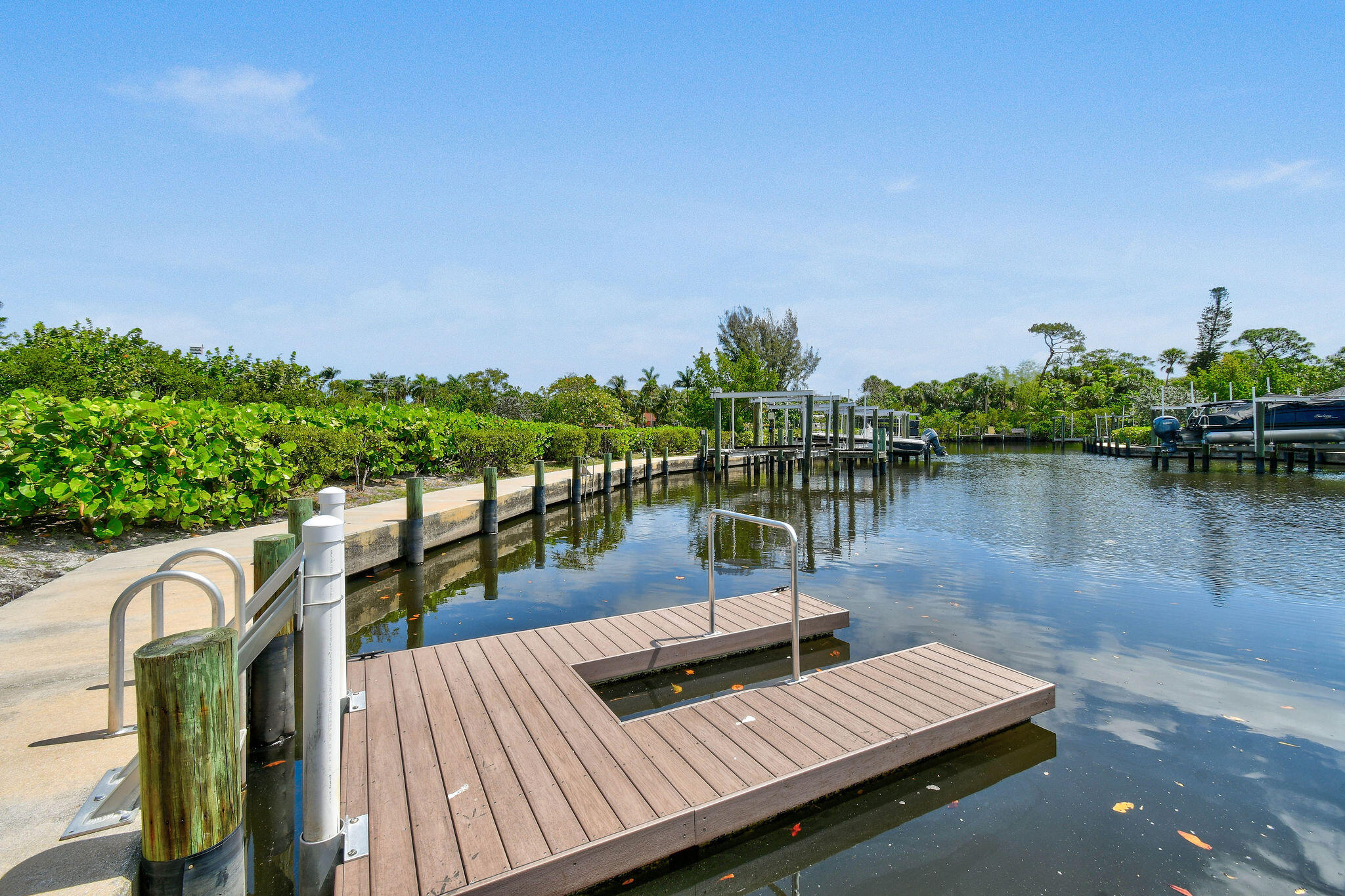 4707 Southeast Manatee Terrace Stuart, FL 34997 - Photo 59 of 68 a view of a lake with couches chairs and wooden floor