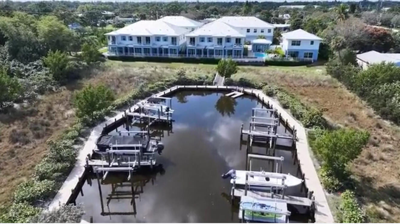 4707 Southeast Manatee Terrace Stuart, FL 34997 - Photo 61 of 68 an aerial view of a house with garden space and lake view