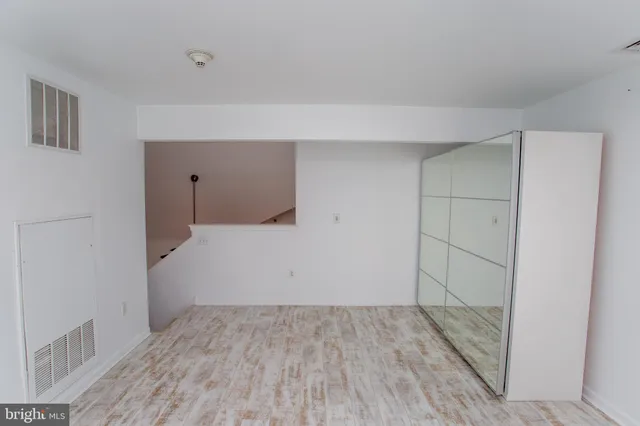 a kitchen with a refrigerator a microwave and wooden floor