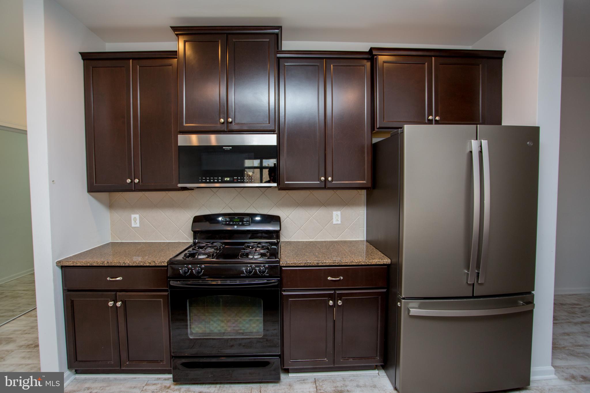 523 Carson Terrace Huntingdon Valley, PA 19006 - Photo 30 of 55 a kitchen with stainless steel appliances granite countertop a refrigerator and a stove