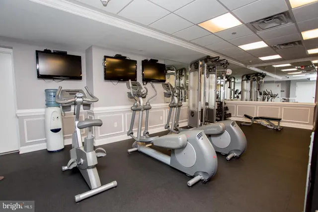 a room with gym equipment and a flat screen tv