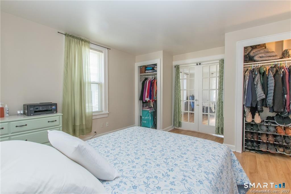 18 Lawrence Street Norwalk, CT 06854 - Photo 16 of 31 a bedroom with a bed and a flat tv screen in it
