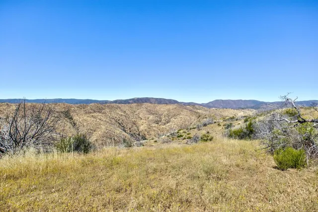a view of a large building with mountains in the background