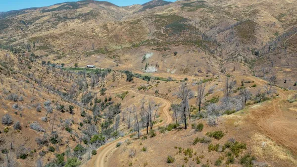a view of a large mountain with mountains in the background