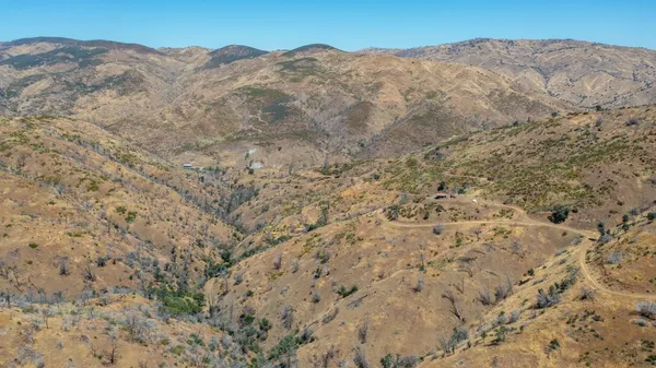 a view of a mountain range in a cloudy sky