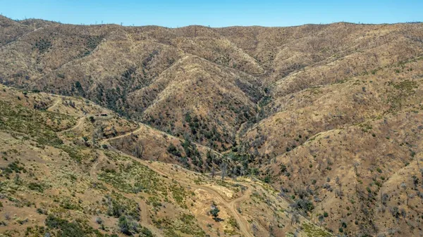 a view of a mountain range with trees in the background