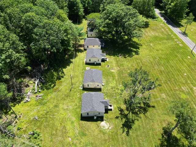 an aerial view of a house with a yard