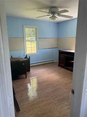 a view of a livingroom with a furniture cabinet and window