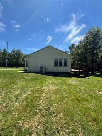 a view of a house with a backyard