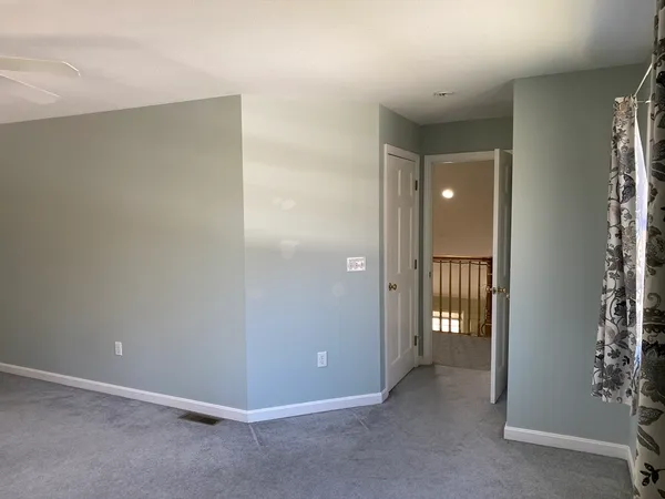 an empty room with closet and a bathroom