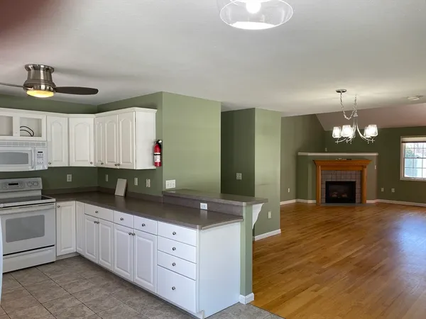 a kitchen with granite countertop a sink cabinets and stainless steel appliances