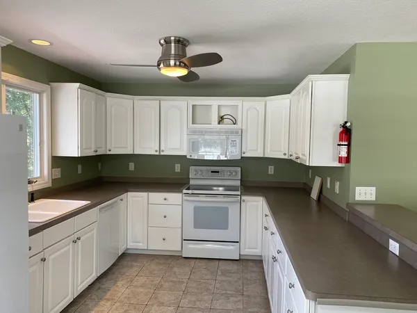 a kitchen with granite countertop a sink stainless steel appliances and cabinets