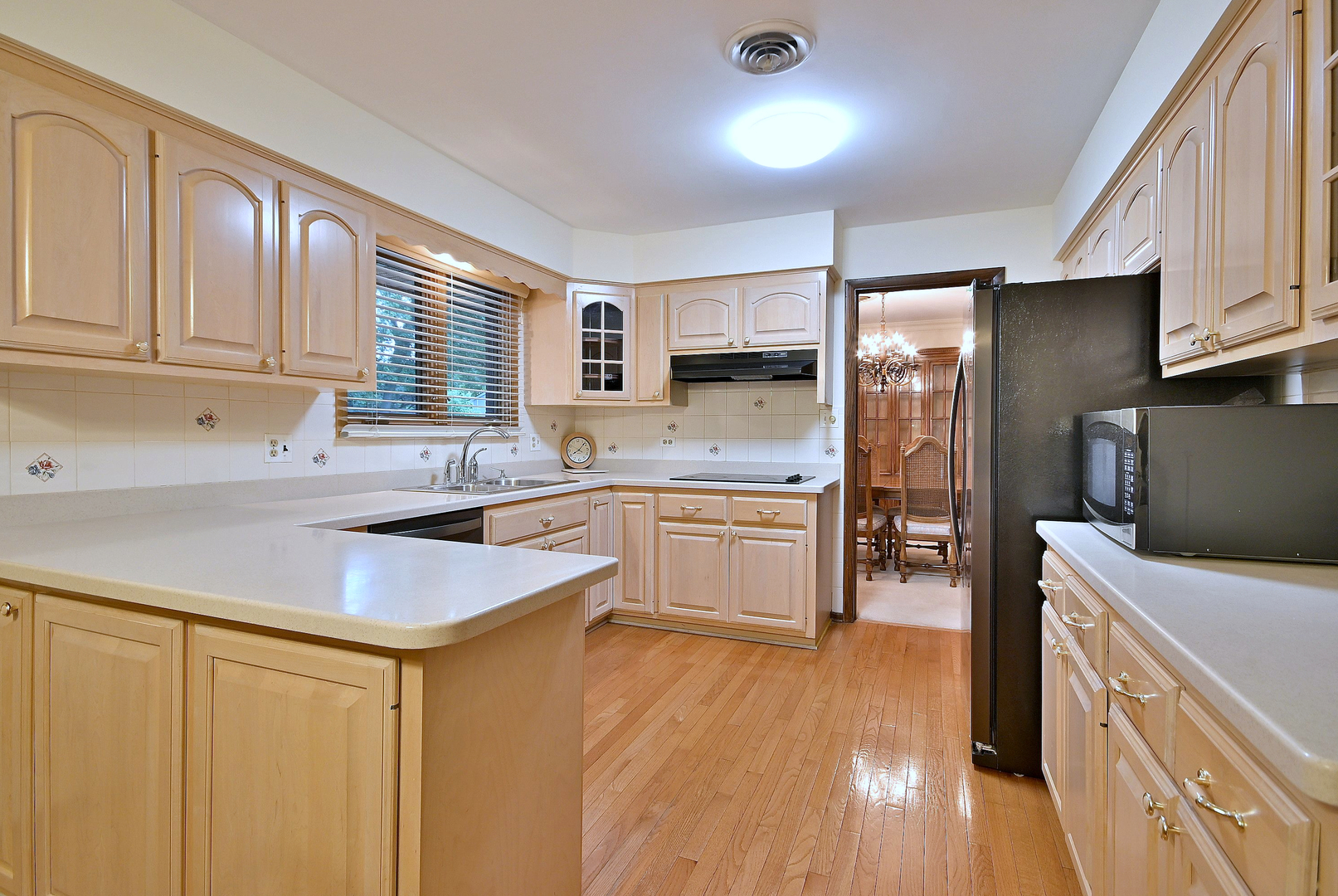 7976 Clarendon Hills Road Willowbrook, IL 60527 - Photo 12 of 41 a kitchen with white cabinets and sink