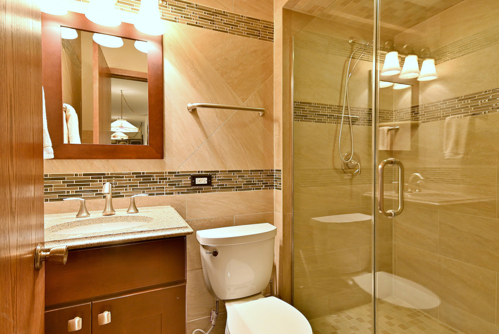 7976 Clarendon Hills Road Willowbrook, IL 60527 - Photo 20 of 41 a bathroom with a toilet sink shower and mirror