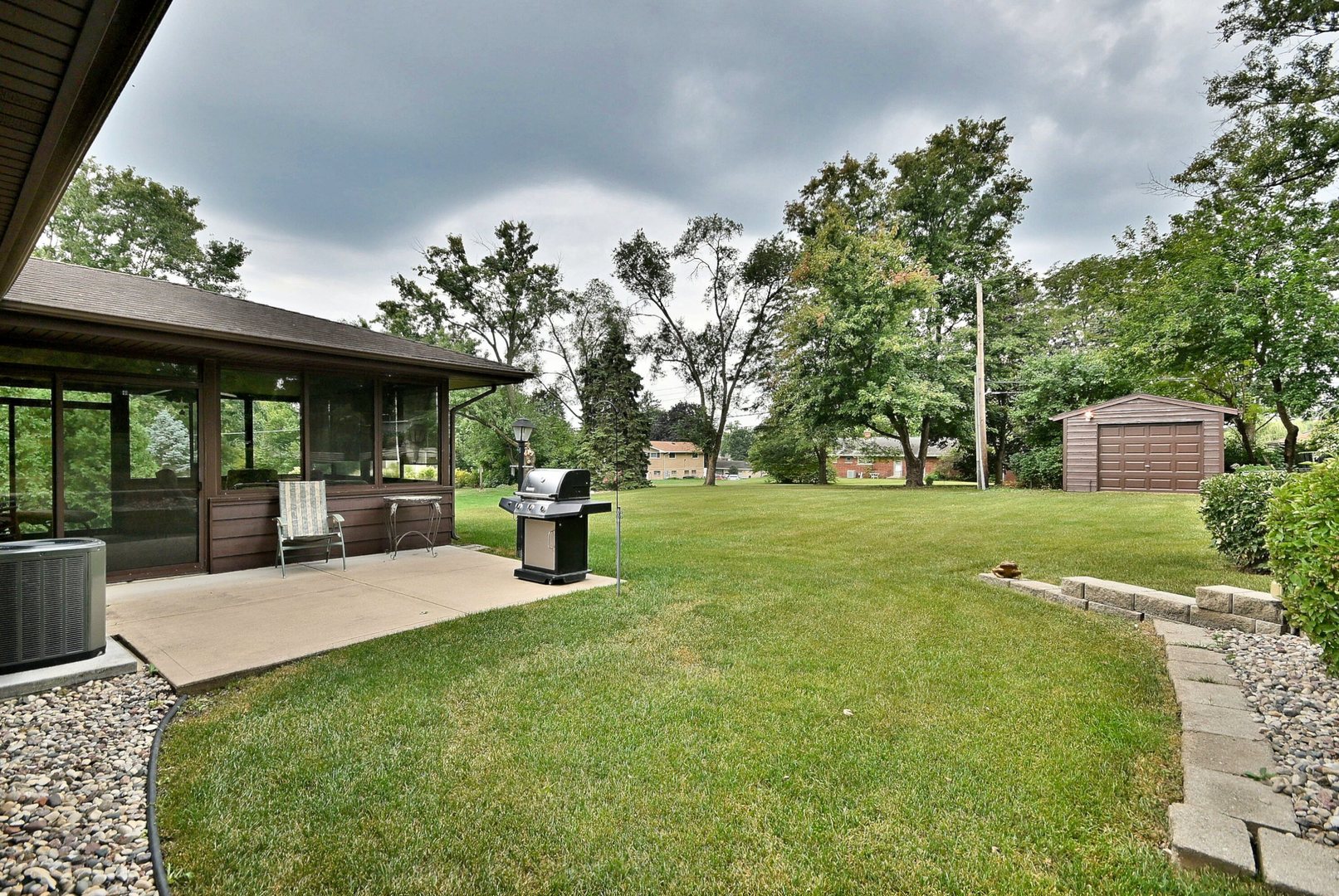 7976 Clarendon Hills Road Willowbrook, IL 60527 - Photo 38 of 41 a view of a house with backyard porch and sitting area