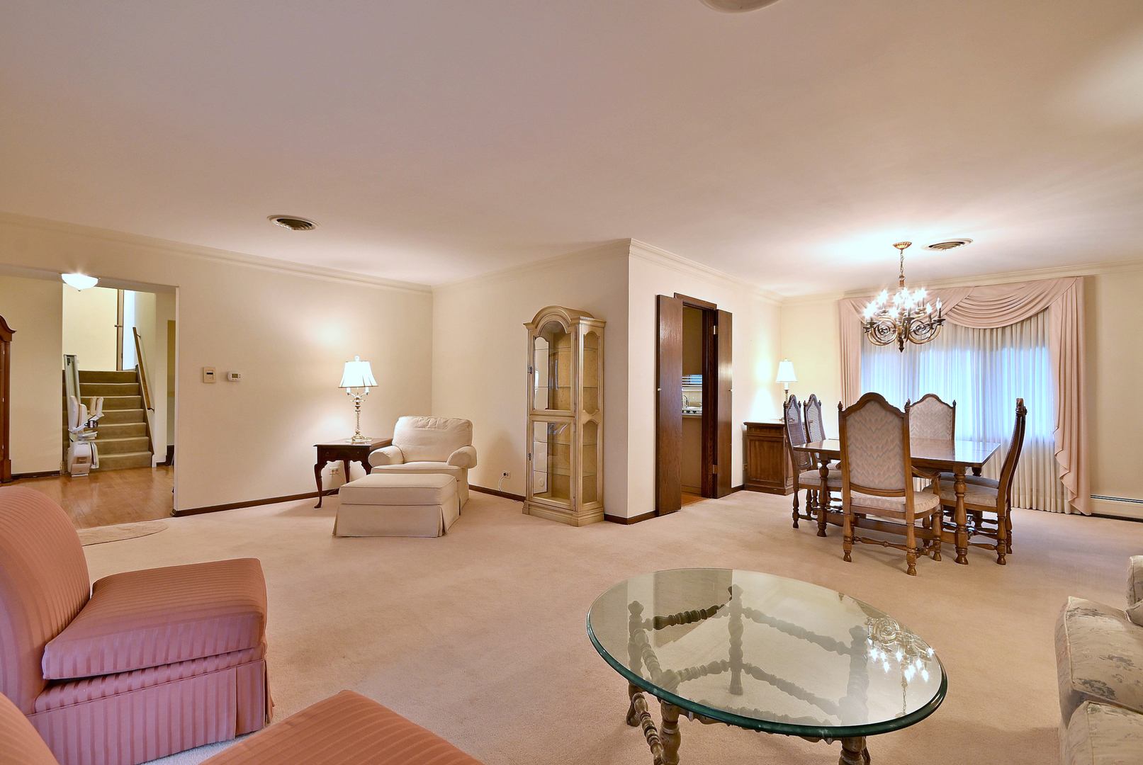 7976 Clarendon Hills Road Willowbrook, IL 60527 - Photo 6 of 41 a living room with furniture and a dining table