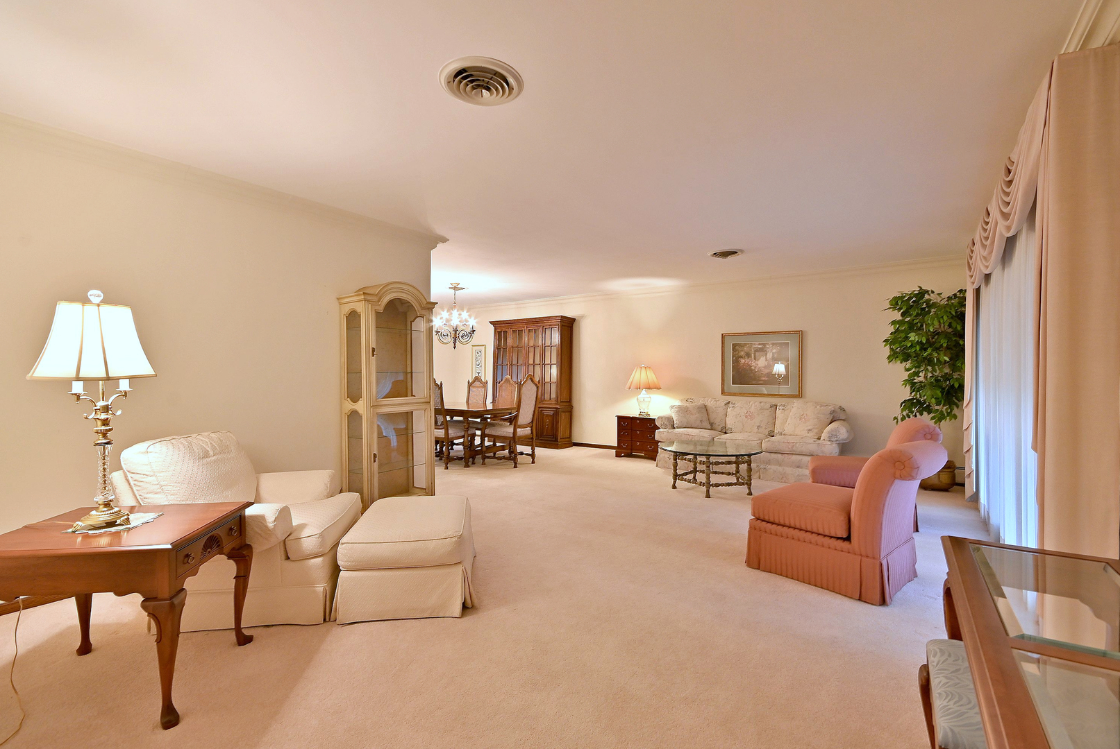 7976 Clarendon Hills Road Willowbrook, IL 60527 - Photo 7 of 41 a living room with furniture and a lamp