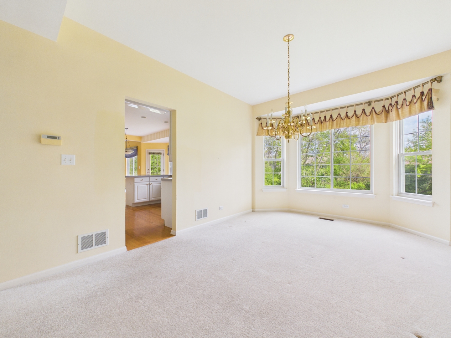 7486 Abbey Road Gurnee, IL 60031 - Photo 7 of 35 a view of an empty room with a window and refrigerator
