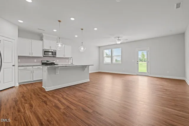 a view of kitchen with cabinets and wooden floor