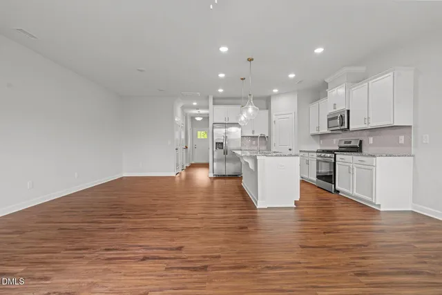 a view of kitchen view with wooden floor and chairs