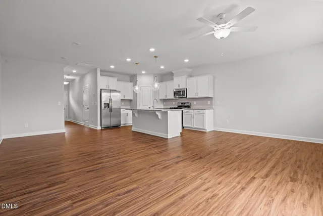 a view of a kitchen with a wooden floor and a kitchen