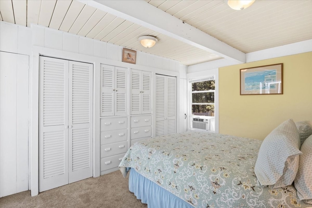 35 Tecumseh Road Wellfleet, MA 02667 - Photo 11 of 24 a spacious bedroom with a bed and a wooden floor