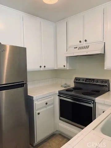 a kitchen with cabinets and appliances