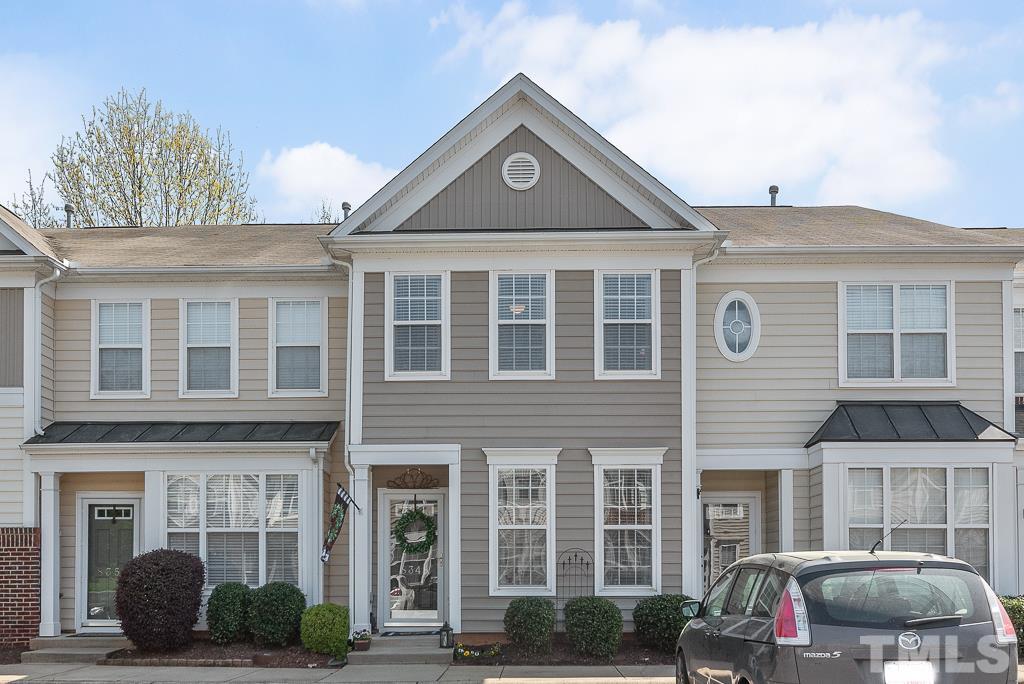 8348 City Loft Court Raleigh, NC 27613 - Photo 1 of 24 a front view of a residential apartment building with a yard