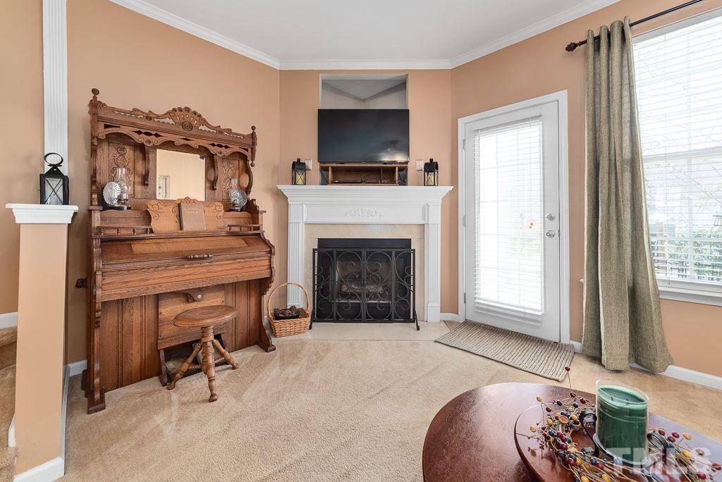 8348 City Loft Court Raleigh, NC 27613 - Photo 13 of 24 a living room with furniture and a fireplace