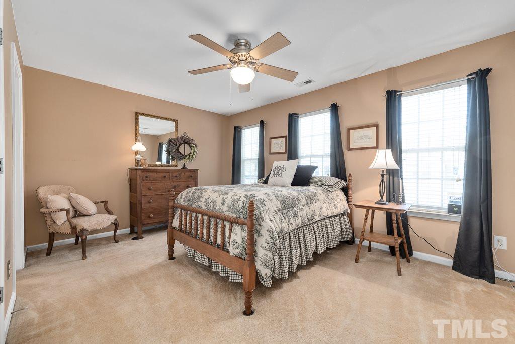 8348 City Loft Court Raleigh, NC 27613 - Photo 15 of 24 a bedroom with a bed a window and couch
