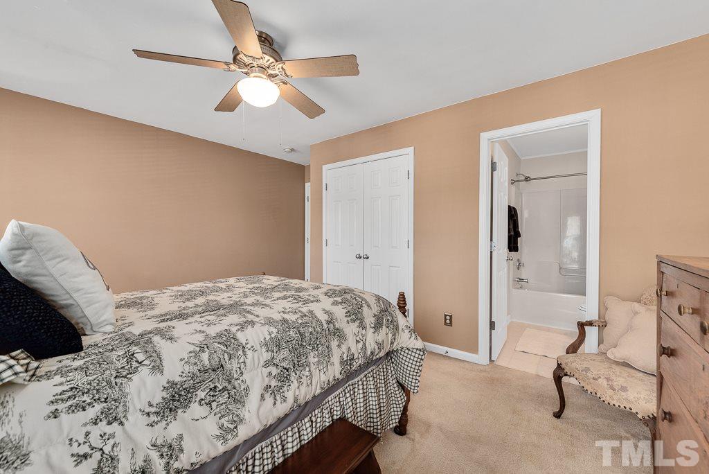 8348 City Loft Court Raleigh, NC 27613 - Photo 16 of 24 a bedroom with a bed and a chandelier